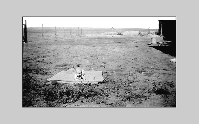 <adrienne on blanket in front yard of ramon ranch no trees>