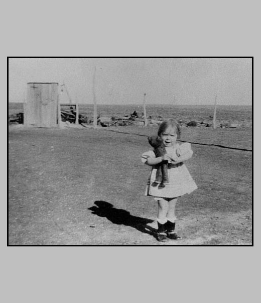 Adrienne with doll in west yard of ramon house