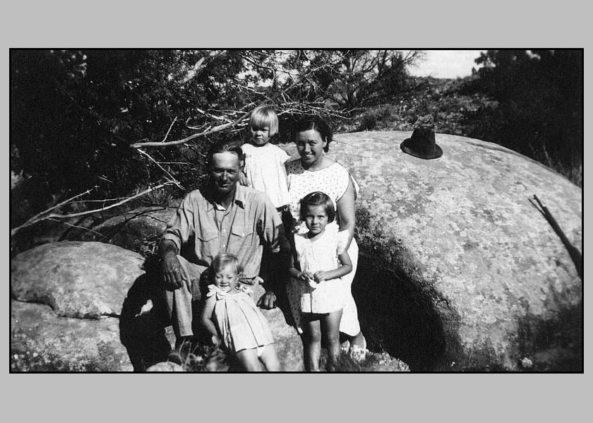 Adron Adrienne Johnie Sheila Donna at the breaks sitting on a large rock. His hat and a rifel can be seen in the photo