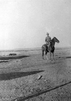 <adron turner posed riding a horse at the starr place>