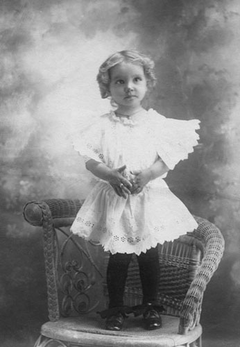 <young johnie studio portrait standing in a chair>