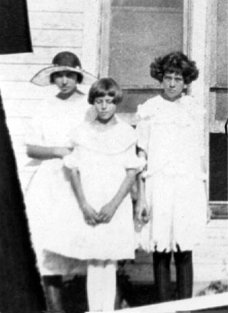 <three downer sisters johnie with large brimmed hat>