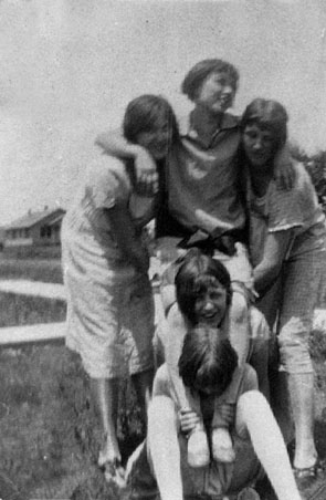 <johnie downer and friends cutting up for the camera, building a pyramid>