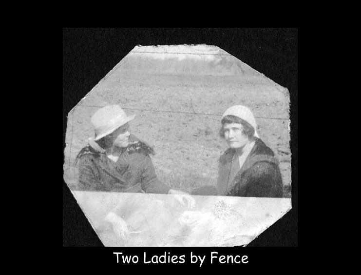 two ladies by fence