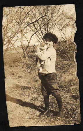 <little boy holding a cat>