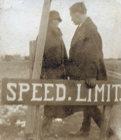 <couple by speed limit sign>