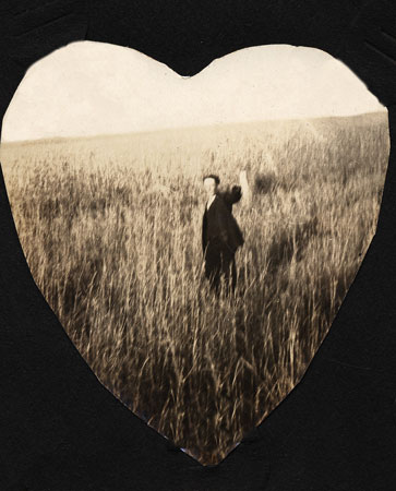 <man stand in field of tall grass. heart sheaped photo mat>