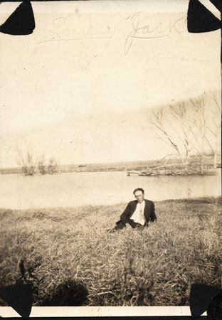 <lovely jack sitting by a lake>