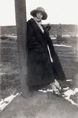 <restored by terry billie jear leaning against a pole snow on the ground creative pose>