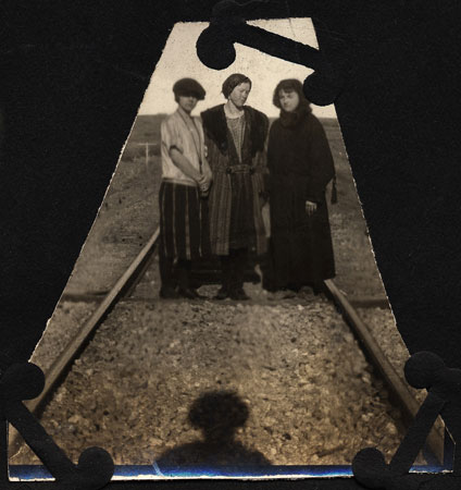 <Three Ladies Standing on Railroad Tracks>