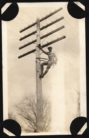 <mam climbing telephone pole>