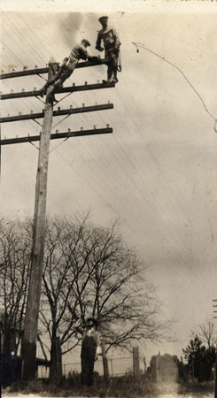 <men working on telephone line>