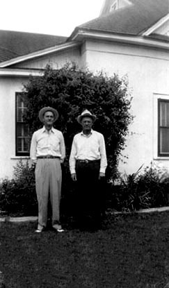 adron turner and unknown person standing on east lawn of portales house
