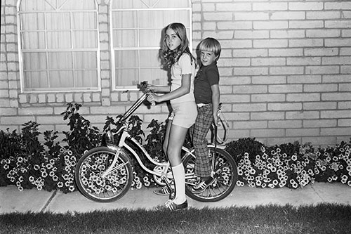 <kelly ron bicycle front yard sycamore dr flowers>