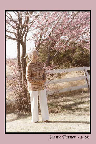 <mom mother johnie tree pink blooms white fence>