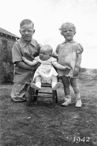 <young charley janell sandra sitting in little chair>