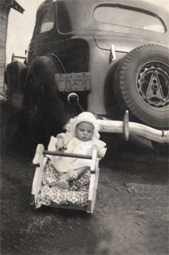 <baby janell rocker by old car>